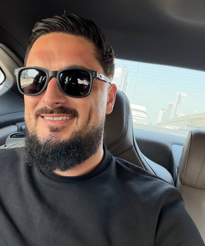 Portrait of Ionut smiling, wearing sunglasses